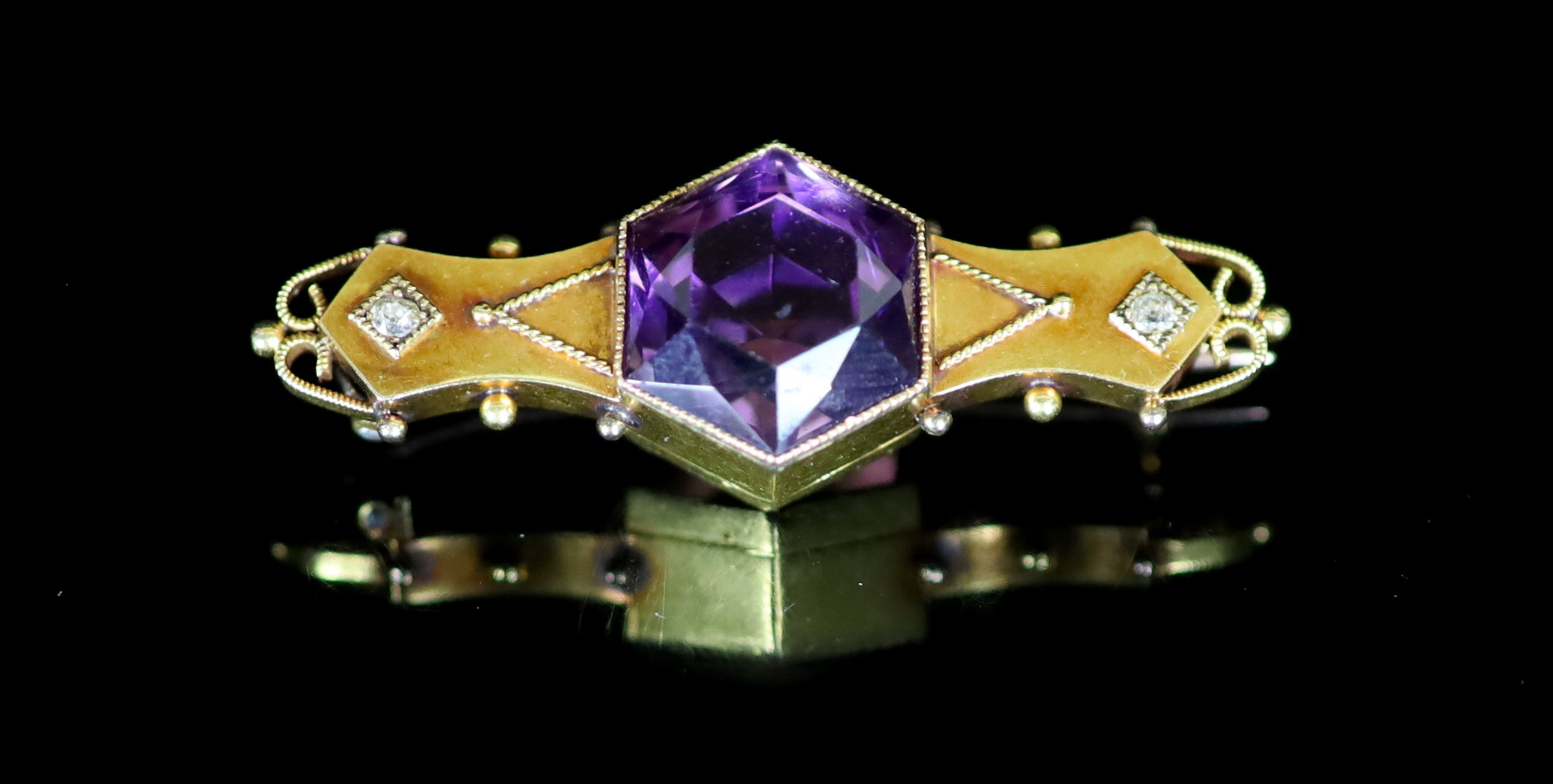 An Edwardian 18ct gold, hexagonal cut amethyst and diamond set three stone bar brooch